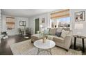Living room featuring a comfortable sofa, natural light, and stylish decor at 1535 Spruce St, Denver, CO 80220