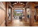 Living room with wood beam details, stone fireplace, and floor-to-ceiling windows offering beautiful views at 2929 Highlands View Rd, Evergreen, CO 80439