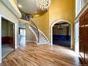 Grand foyer featuring a curved staircase, hardwood floors, and open sightlines at 8461 Pawnee Ln, Niwot, CO 80503