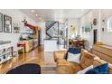 Open floor plan showcasing the living room, kitchen, dining area, and modern staircase at 4129 Zenobia St, Denver, CO 80212