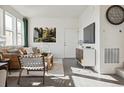 Bright and airy living room featuring modern decor, wood floors, and large windows at 9865 Biscay St, Commerce City, CO 80022