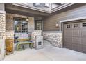 Inviting front porch with stone pillars and outdoor seating area at 1495 W 137Th Ave, Broomfield, CO 80023