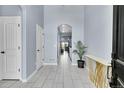 Bright foyer with tile flooring, arched entryway, and stylish console table at 6829 Juniper Ct, Frederick, CO 80530