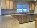 Updated kitchen featuring granite countertops and stainless steel dishwasher at 2101 S Lowell Blvd, Denver, CO 80219