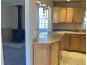 Eat in kitchen with light wood cabinets and adjacent living area with fireplace at 2101 S Lowell Blvd, Denver, CO 80219