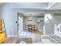 Bright living room seamlessly connects to the dining area and kitchen, creating an open and inviting space at 3849 E 121St Ave, Thornton, CO 80241