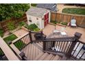 Multi-tiered deck with brick patio, shed, and fenced yard at 10218 Woodrose Ct, Highlands Ranch, CO 80129