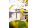 Charming home exterior with a three-car garage and well-kept lawn at 10218 Woodrose Ct, Highlands Ranch, CO 80129