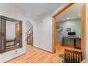 Inviting entryway with hardwood floors, decorative mirror and staircase to the upper level at 119 Ward Ct, Lakewood, CO 80228