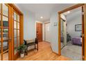 Welcoming entryway featuring hardwood floors, a bench, and views into other rooms at 119 Ward Ct, Lakewood, CO 80228