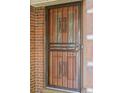 Elegant front door with decorative glass and a secure metal screen at 1844 S Pontiac Way, Denver, CO 80224