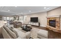 Bright living room with a stone fireplace, recessed lighting, and hardwood floors at 1983 Candleglow St, Castle Rock, CO 80109