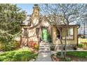 Attractive brick home with a lush lawn, garden beds, and a bright green front door at 510 16Th St, Golden, CO 80401