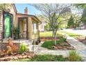 Landscaped front yard featuring a well-maintained lawn, garden beds and stone edging at 510 16Th St, Golden, CO 80401