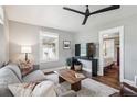 Cozy living room features hardwood floors, a ceiling fan, and a view into the bedroom at 4190 S Grant St, Englewood, CO 80113