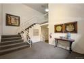 Welcoming lobby area with a staircase, decorative art, and a cozy ambiance at 5751 E Ithaca Pl # 3, Denver, CO 80237