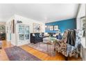 Cozy living room with hardwood floors, stylish decor, and comfortable seating arrangement at 7034 S Cherry St, Centennial, CO 80122