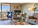 A cozy living room featuring a work space, comfortable furniture, and natural light at 1085 N Lafayette St # 702, Denver, CO 80218