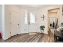 Bright foyer with hardwood floors, glass-paneled door, and neutral decor at 3492 N Buchanan Way, Aurora, CO 80019
