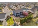Aerial view of the home's backyard with deck and landscaping, offering a private outdoor space at 684 Poppy Pl, Highlands Ranch, CO 80129