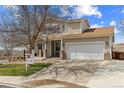 Charming two-story home features a two-car garage and manicured front yard at 10885 Longs Peak Ln, Parker, CO 80138
