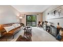 Inviting living room with comfortable seating, a modern entertainment center, and balcony access at 7770 W 38Th Ave # 207, Wheat Ridge, CO 80033