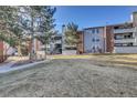 Beautiful condo building with a well-kept lawn, inviting facade, balconies, and staircase at 14467 E 1St Dr # A04, Aurora, CO 80011