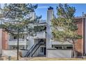 Charming condo building with inviting facade, balconies, a staircase, and well-maintained landscaping at 14467 E 1St Dr # A04, Aurora, CO 80011