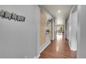 Long hallway with contemporary decor, wooden floors, and a view into the dining area at 675 W 171St Pl, Broomfield, CO 80023