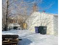 Backyard with detached garage and snow at 1274 Hudson St, Denver, CO 80220