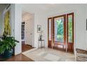 Bright foyer featuring tile flooring, a striking wooden door, and stylish decor at 4577 Elm Ct, Denver, CO 80211