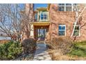 Inviting front entrance showcasing a classic brick facade, and well-manicured landscaping at 4577 Elm Ct, Denver, CO 80211