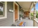 Inviting front porch with a wooden swing, stylish decor, and a 'Oh Hello' welcome mat at 503 15Th St, Golden, CO 80401