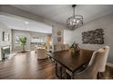 Elegant dining room with dark wood table and stylish light fixture at 8308 W 90Th Ave, Westminster, CO 80021