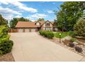 Attractive home with large driveway, beautiful landscaping and a three-car garage at 4180 S Yukon Way, Lakewood, CO 80235