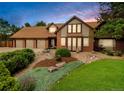 Attractive home with beautiful landscaping, a three-car garage and a brick facade at 4180 S Yukon Way, Lakewood, CO 80235