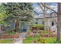 Charming home with a beautifully landscaped front yard, featuring stone accents and vibrant tulips at 2514 N Humboldt St, Denver, CO 80205