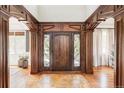 Grand foyer featuring custom woodwork, a stylish front door with sidelights, and ceramic tile flooring at 5550 Preserve Dr, Greenwood Village, CO 80121