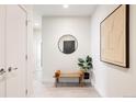 Inviting hallway with a decorative mirror, bench, and wall art, enhancing the home's modern aesthetic at 2880 Zuni St # 408, Denver, CO 80211