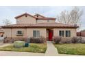 Attractive home exterior with a red front door, manicured lawn, and desert landscaping at 4543 S Auckland Ct, Aurora, CO 80015