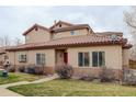 Inviting exterior showcasing a red front door, tile roof and well-maintained lawn at 4543 S Auckland Ct, Aurora, CO 80015