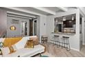 Cozy living room featuring a modern sofa, barn door accent, and stylish breakfast bar at 100 S Clarkson St # 105, Denver, CO 80209