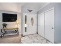 Welcoming foyer with marble flooring, closet and front door with decorative glass at 3647 S Uravan St, Aurora, CO 80013