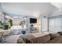 Comfortable living room with a view of the entryway, with carpet and large windows at 3647 S Uravan St, Aurora, CO 80013
