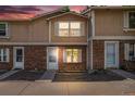 Brick townhome exterior with a cozy entrance, sidewalk, and partial siding at 1534 S Ouray Cir # B, Aurora, CO 80017