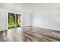Bright living room featuring sleek flooring and a sliding glass door with a view to the outside at 1534 S Ouray Cir # B, Aurora, CO 80017