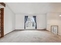 Bright living room with a large window and neutral carpet at 10241 Routt St, Broomfield, CO 80021