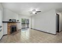 Spacious living room with tiled flooring, fireplace and a sliding glass door to balcony at 14590 E 2Nd Ave # B309, Aurora, CO 80011