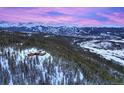 Aerial view of a luxury home nestled in a snowy mountain landscape at 300 Little Sallie Barber Trl, Breckenridge, CO 80424