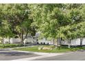Well-maintained house featuring lush landscaping, a rock feature, and a tidy corner lot at 3901 S Dexter St, Cherry Hills Village, CO 80113